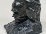 sculpture of a woman ' s head on a black marble base