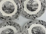 six black and white plates with a picture of a man on a horse