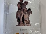 a box with a statue of a man and a dog