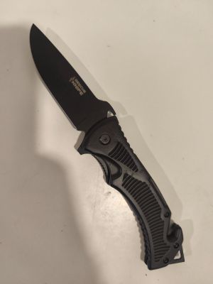 a black knife that is laying on a table