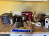 a counter top with a bunch of appliances on it