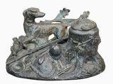 une statue représentant un chien sur un bateau, avec un chien dessus