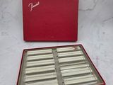 a red box filled with silver and white chocolates on top of a marble counter