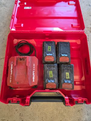 a red tool box that has four batteries in it