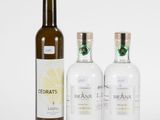 three bottles of vodka and a bottle of wine sitting next to each other