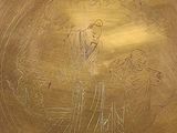 a gold vase with a drawing of a man and a woman on it