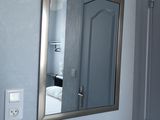 a mirror hanging on the wall in a small room