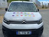 a white van parked on the side of the road with a rainbow sticker on it