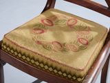 a wooden chair with a seat cushion on it
