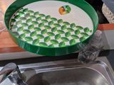 a green plate with a picture of an apple on it
