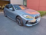 the bmw m140i is parked in front of a building