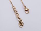 a pair of gold chain necklaces on a white background