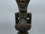 an old wooden statue of a man holding a baby in his arms