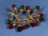 an image of a brooch with red, green, and gold beads