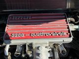 a close up of a car engine with a red cover