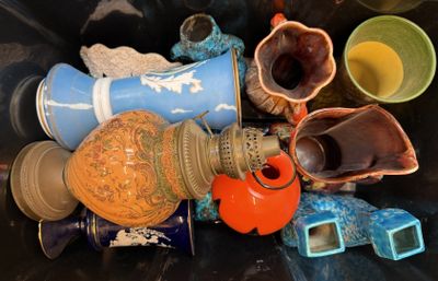 many different vases and bowls in a bin