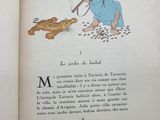 an open book with a picture of a man and a cat on it