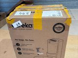 packaging of a boxed coffee maker sitting on top of a cardboard box