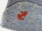 a close up of a hat with a red crab on it