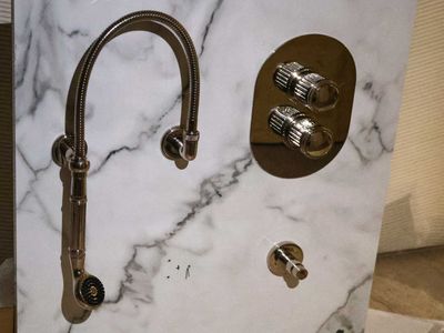 a white marble counter top with a faucet and a faucet