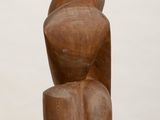 an image of a wooden sculpture on a pedestal on a white surface