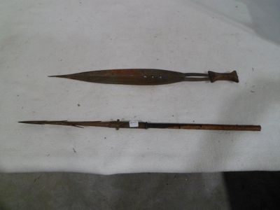 two different types of weapons on a white cloth