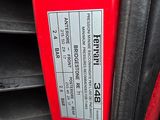 a close up of a red car door handle with a sticker on it