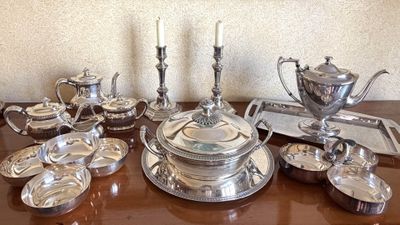 a table with a lot of silver items on it