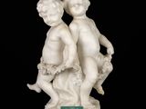 pair of white marble figurines of a boy and a girl
