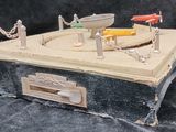 a toy model of a fishing boat on a box