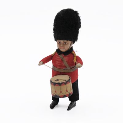 toy soldier holding a drum and wearing a red uniform
