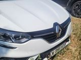 the white car is parked in the grass next to other cars