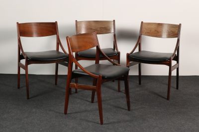 three wooden chairs with black leather upholstered seats in a room