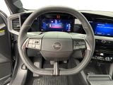 the interior of a car with a steering wheel and dashboard controls