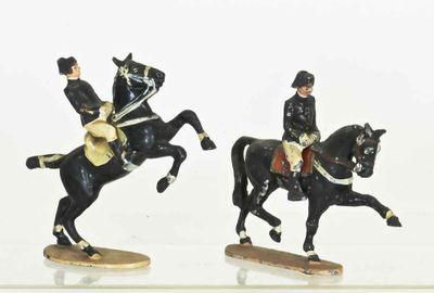 two figurines of a man on a horse and a man on a horse