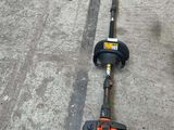 an image of a string trimmer laying on the ground