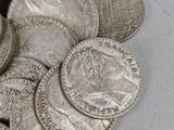 a pile of silver coins sitting on a table