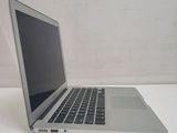 a silver laptop computer sitting on a white table
