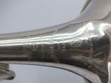 a silver trumpet that is sitting on a table