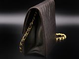 a black purse with a chain hanging from it
