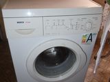 a washing machine sitting in the corner of a room