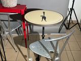 three chairs and a table with a basket on top of it