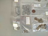 a lot of coins and coins in bags on the table