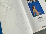 an open book with a drawing of a woman in a bikini on it