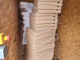 a stack of pizza boxes sitting on a wire rack