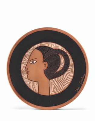 an image of a plate with a woman ' s face painted on it