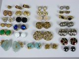 many different types of earrings on a white surface