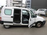 a white van with its door open in a parking lot