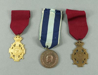 three medals and a medal on a white surface