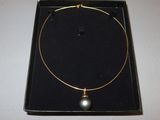 gold plated necklace with a black pearl on a gold plated choke